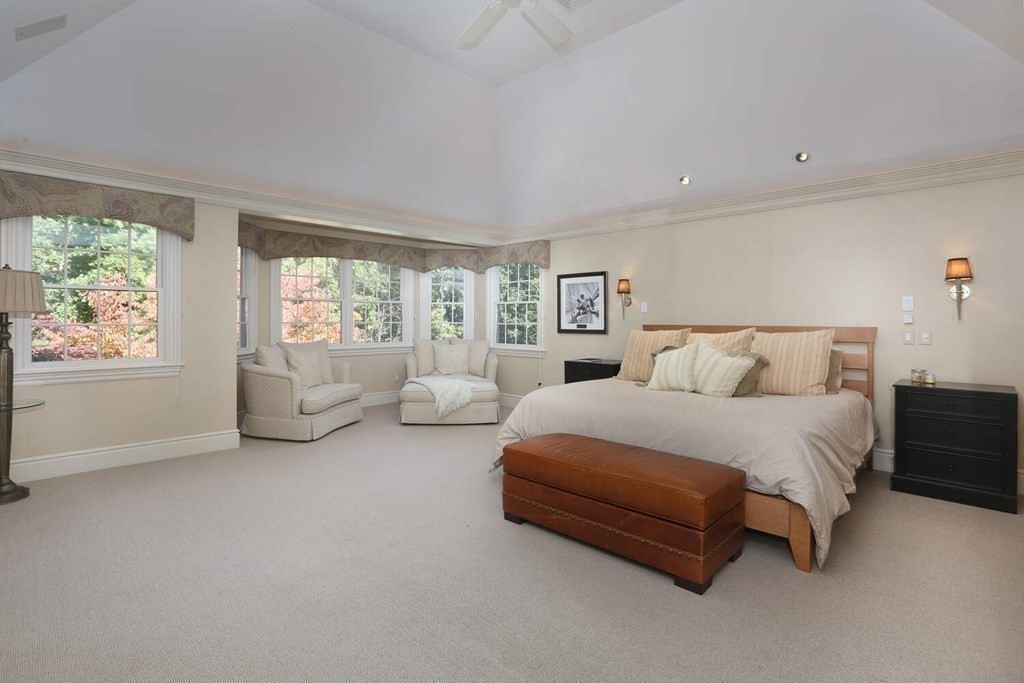 177 Bridle Trail Road Needham, MA 02492 - Photo 15 of 41 a spacious bedroom with a bed and a couch next to a window