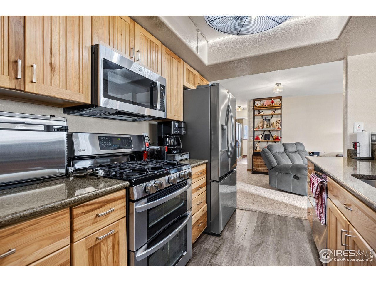 210 2nd Street Mead, CO 80542 - Photo 11 of 29 a kitchen with stainless steel appliances granite countertop a stove and a microwave