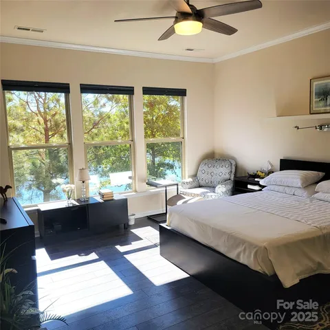 a bed sitting in a spacious bedroom next to a window
