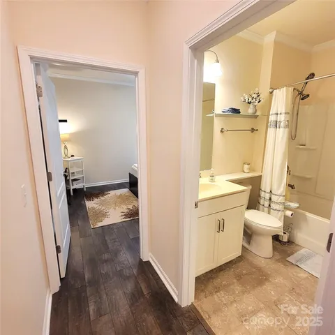 a bathroom with a sink toilet and shower
