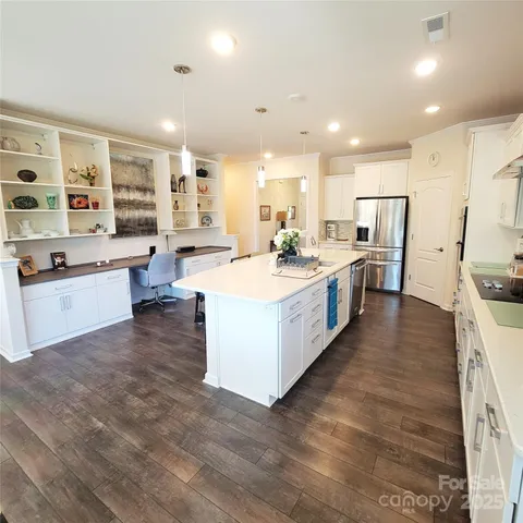 a large kitchen with stainless steel appliances lots of counter top space