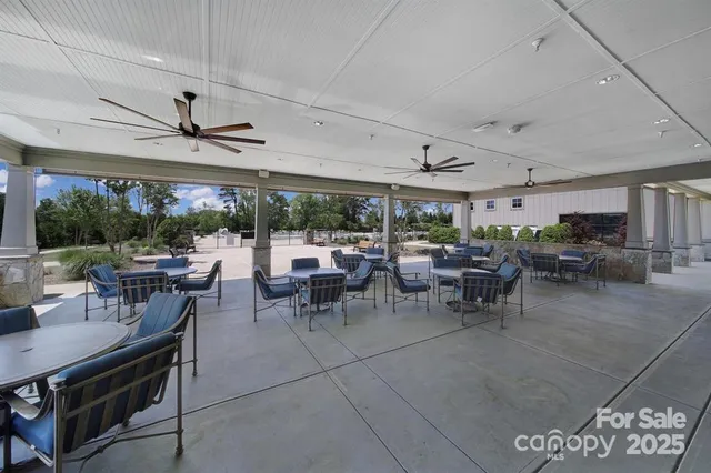 a view of a livingroom with gym equipment and a large window