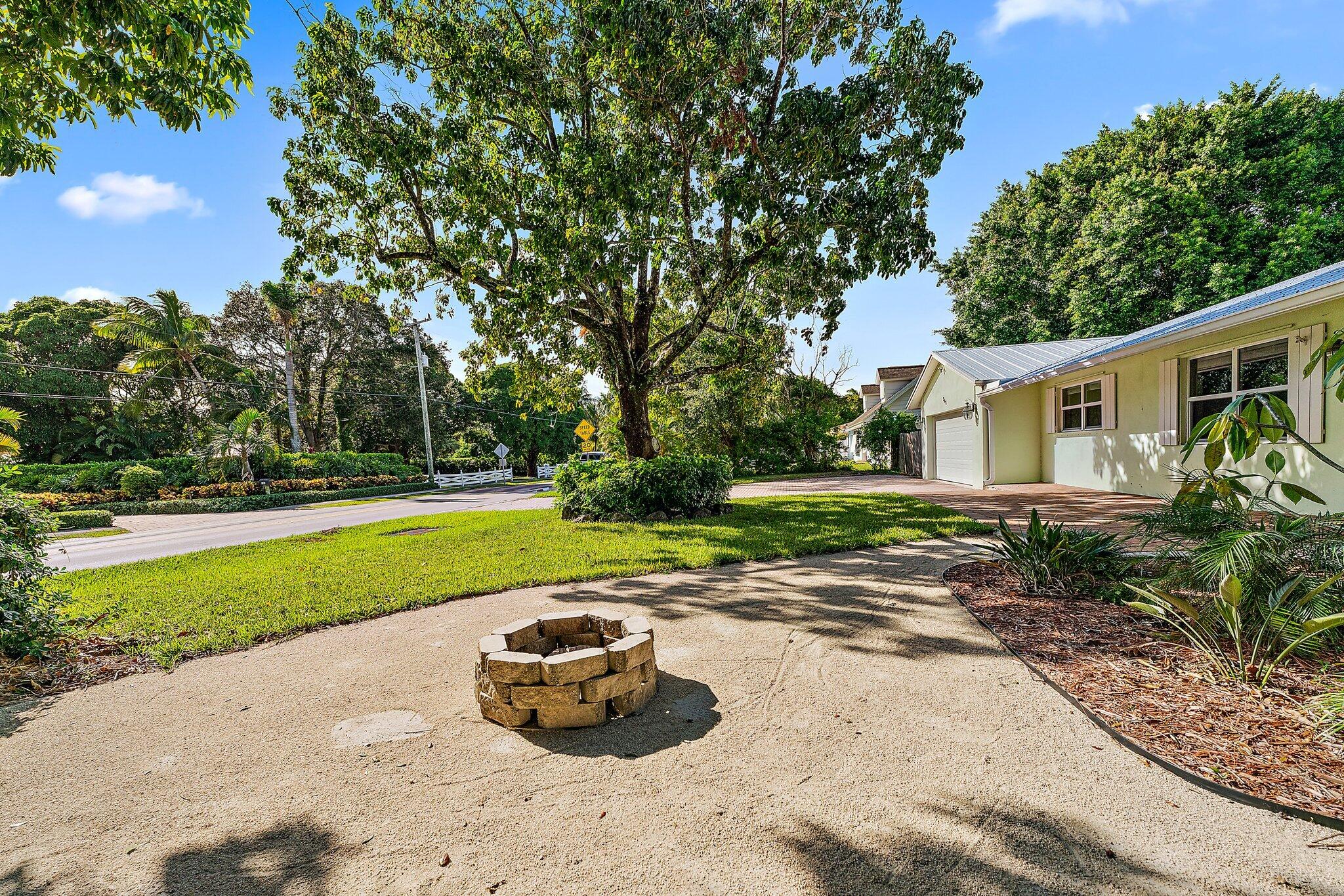 243 West Riverside Drive Jupiter, FL 33469 - Photo 3 of 67 a view of a house with backyard and sitting area