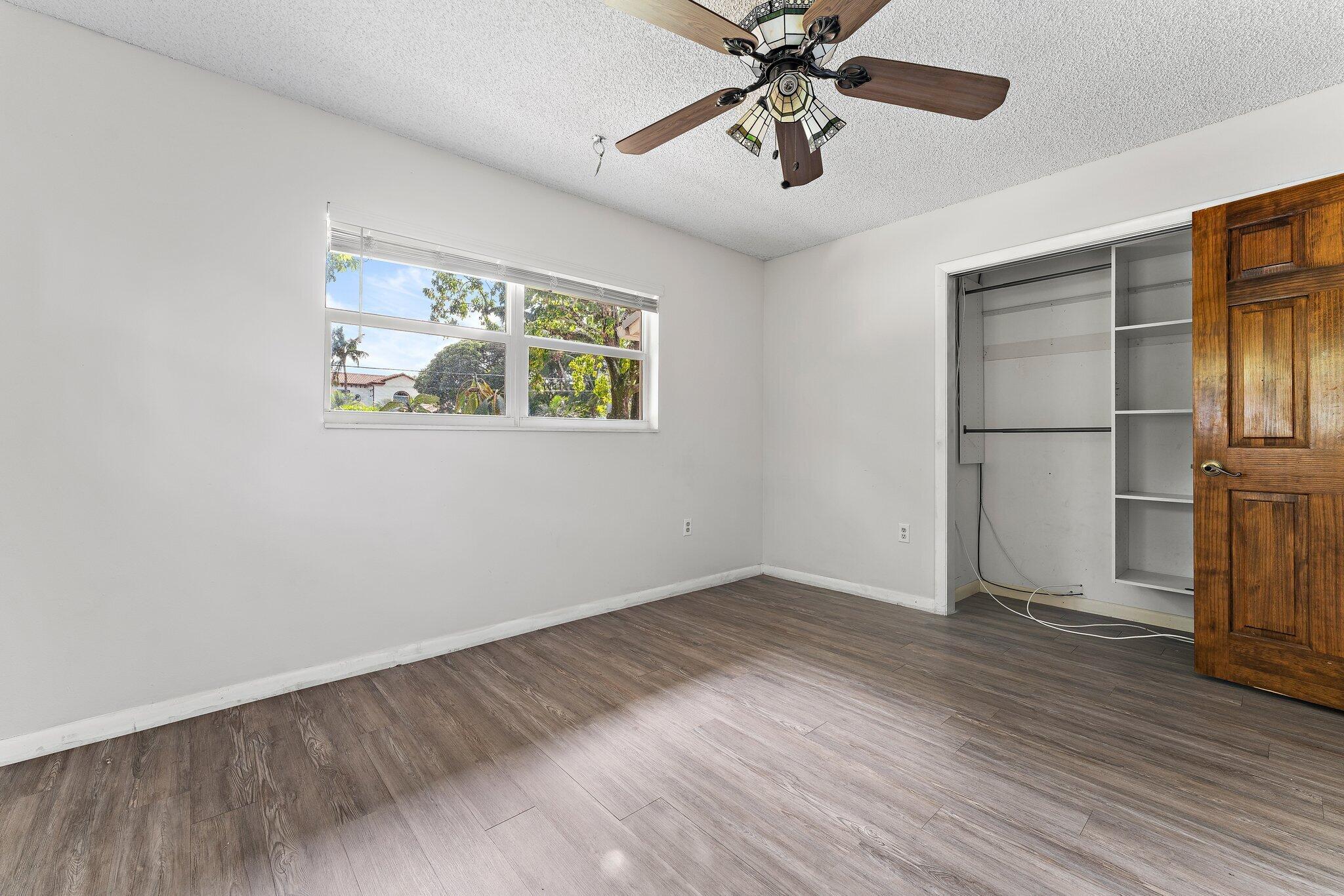 243 West Riverside Drive Jupiter, FL 33469 - Photo 40 of 67 a view of an empty room with wooden floor and a window