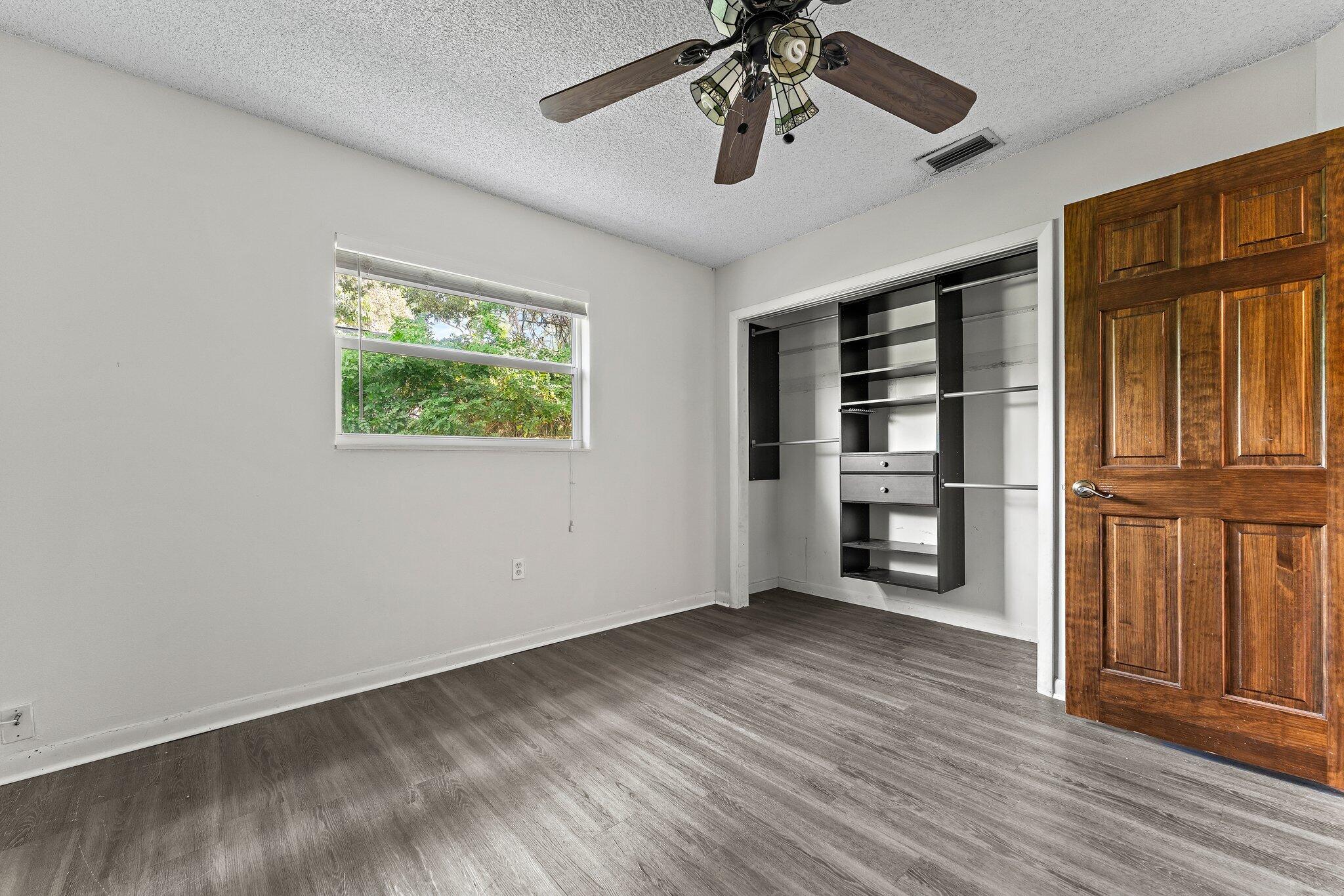243 West Riverside Drive Jupiter, FL 33469 - Photo 42 of 67 wooden floor in an empty room with a window