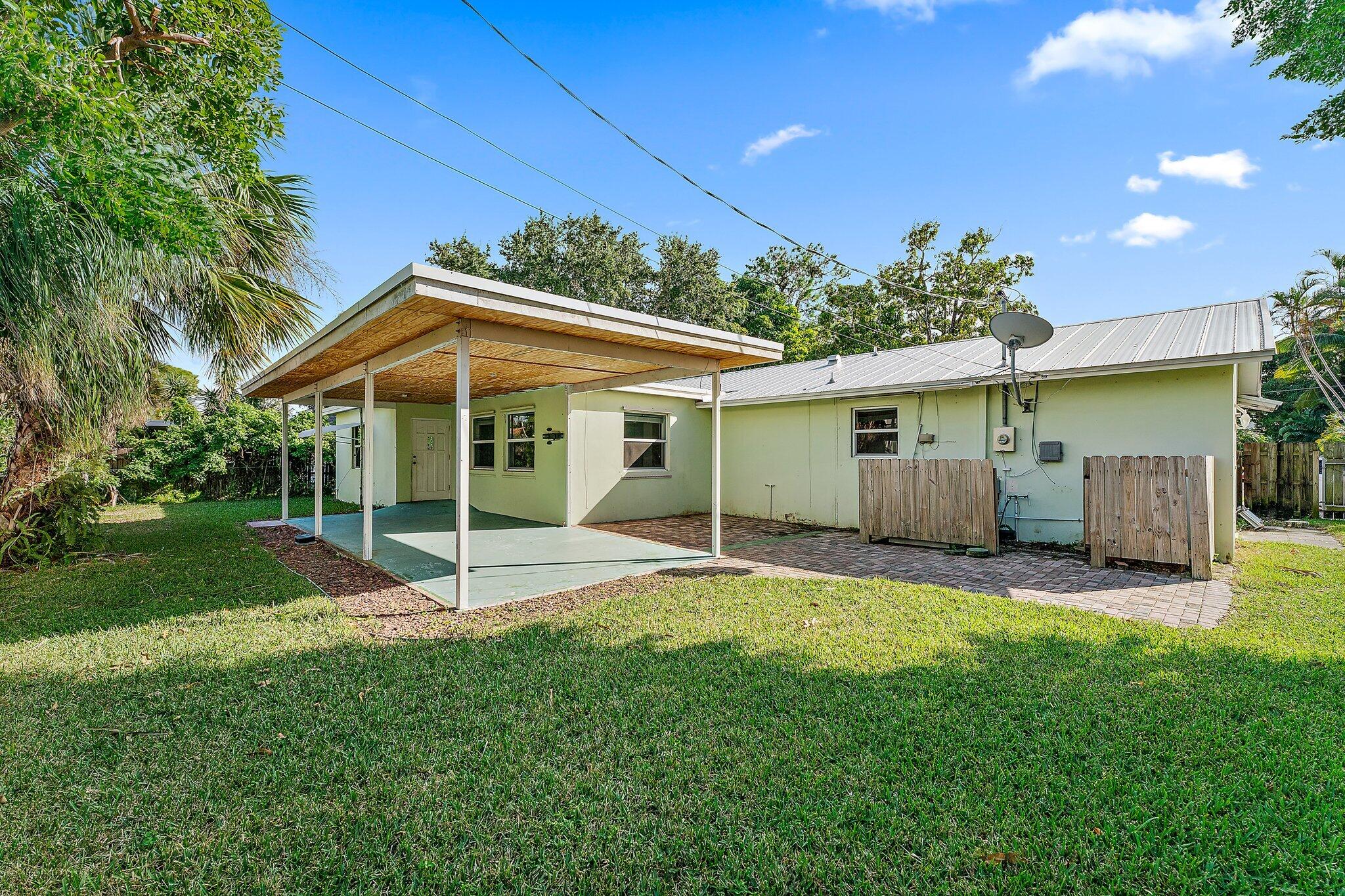 243 West Riverside Drive Jupiter, FL 33469 - Photo 47 of 67 a view of a house with a yard and porch