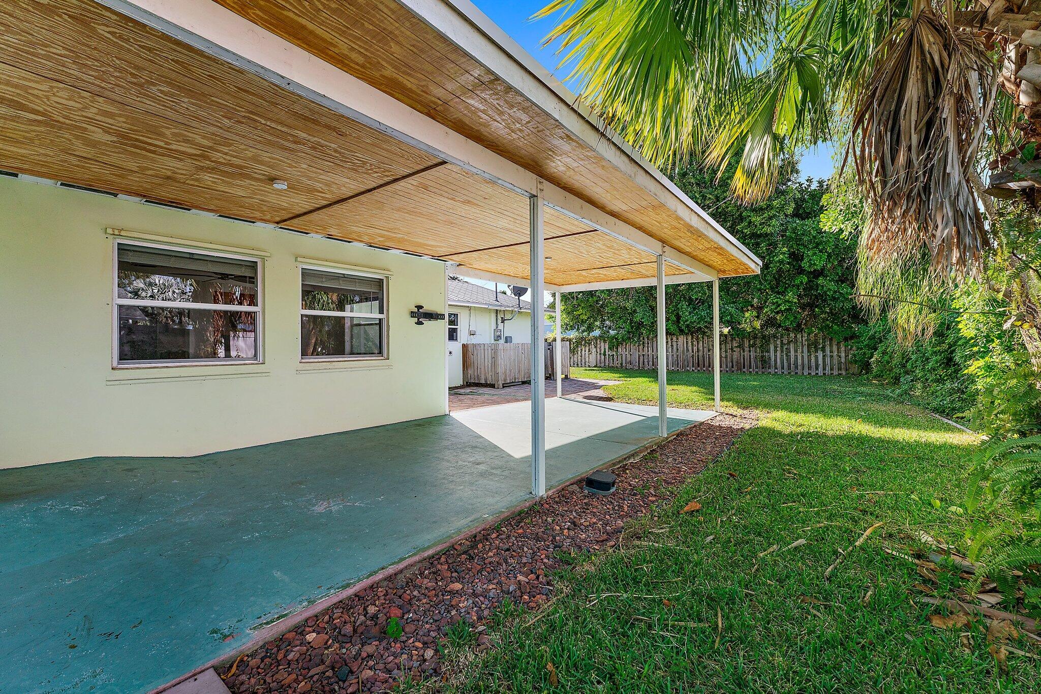 243 West Riverside Drive Jupiter, FL 33469 - Photo 48 of 67 a view of a house with backyard and sitting area