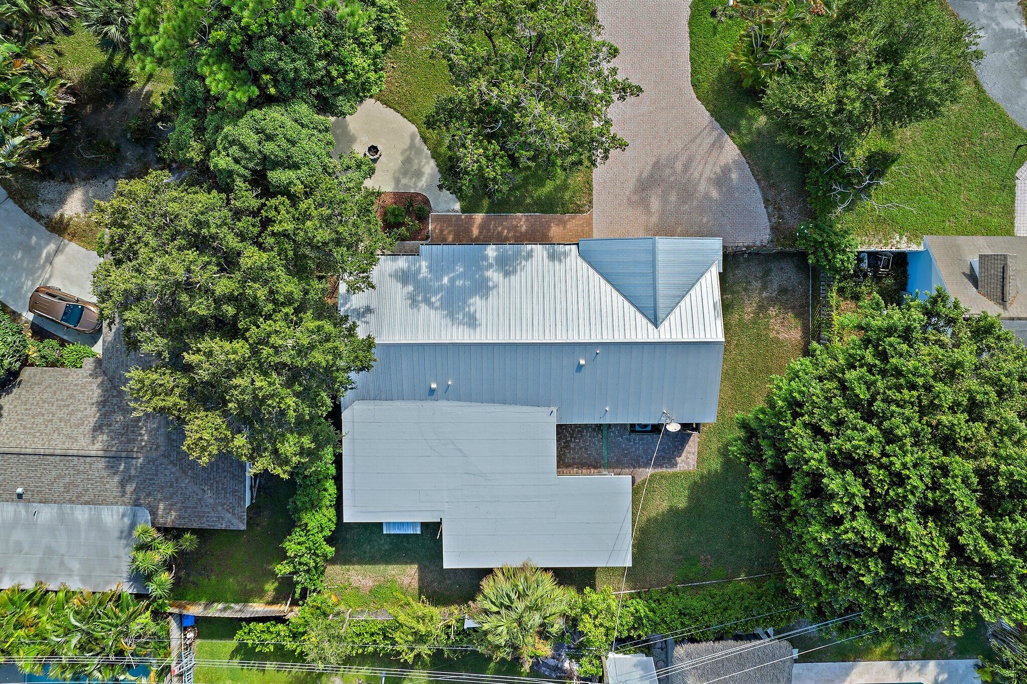 243 West Riverside Drive Jupiter, FL 33469 - Photo 55 of 67 an aerial view of a house with a yard and large tree