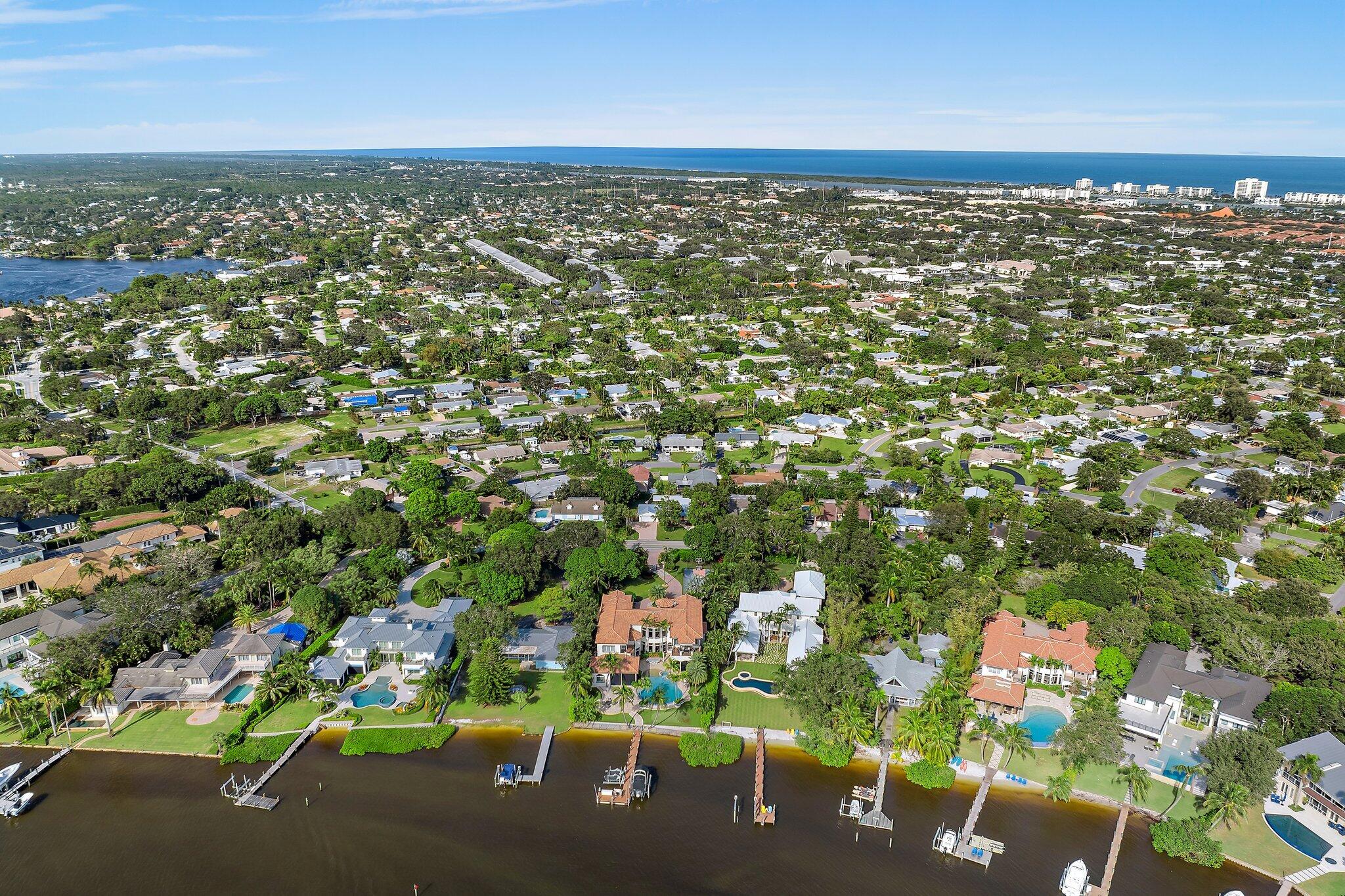 243 West Riverside Drive Jupiter, FL 33469 - Photo 56 of 67 an aerial view of residential houses with outdoor space and trees