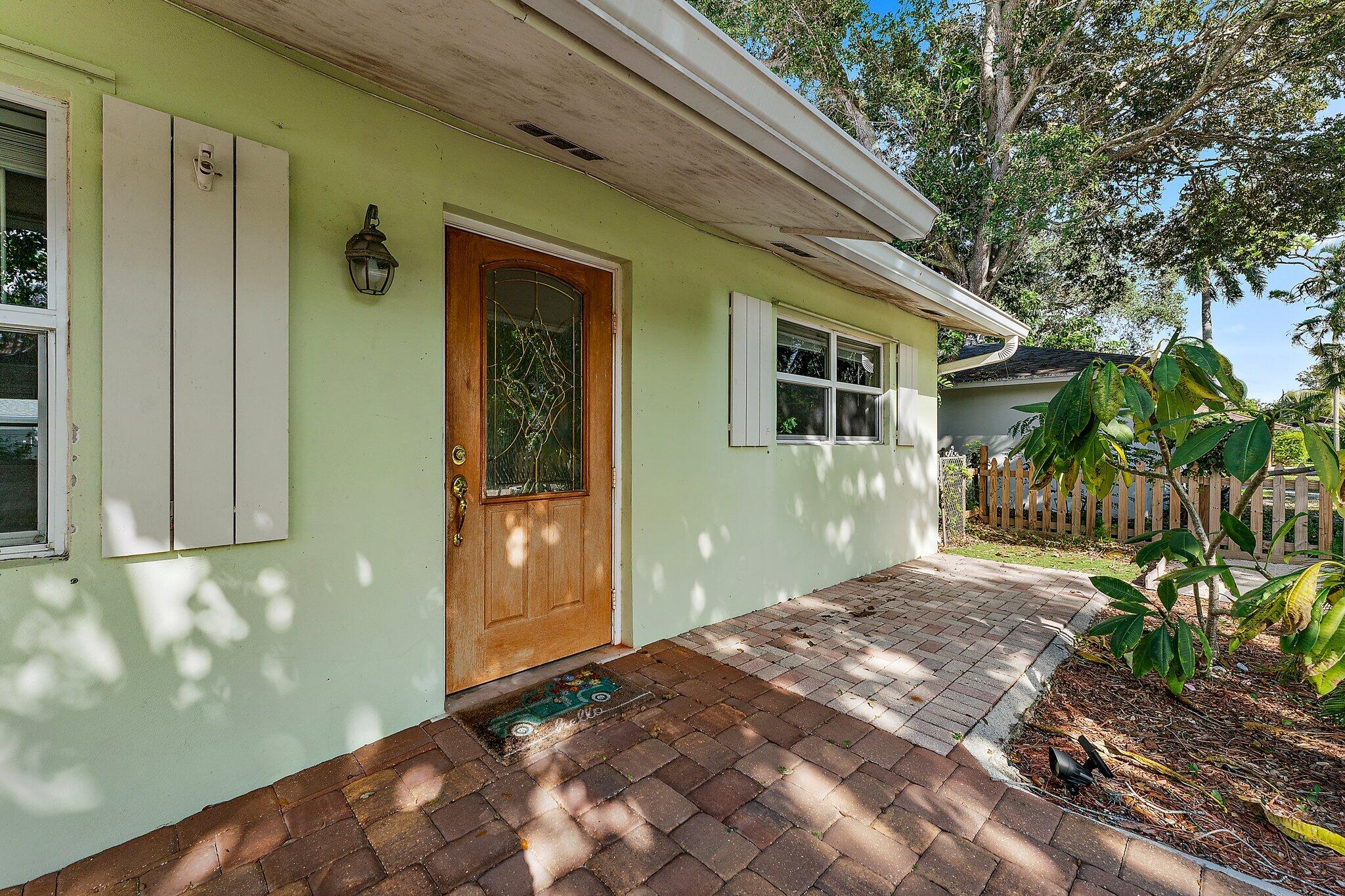 243 West Riverside Drive Jupiter, FL 33469 - Photo 8 of 67 a front view of a house