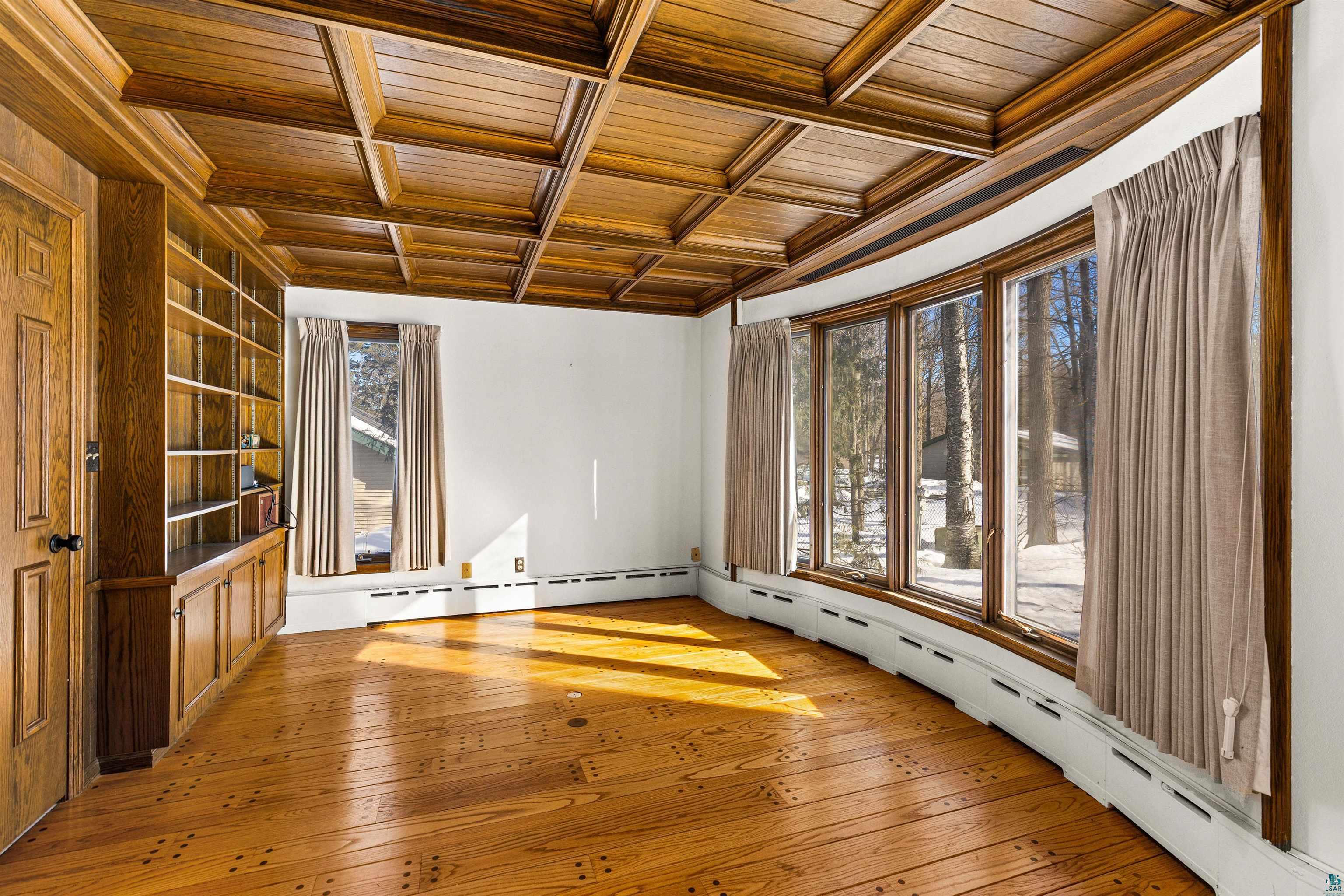 5781 South Pike Lake Road Duluth, MN 55811 - Photo 35 of 42 Spare room with wooden ceiling, baseboard heating, coffered ceiling, light wood finished floors, and plenty of natural light