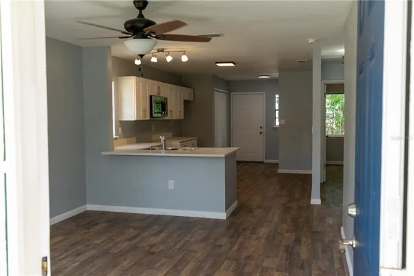 a large bathroom with a sink a mirror and a bathtub