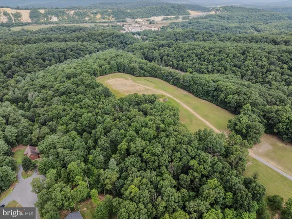 an aerial view of a house with a yard and lake view