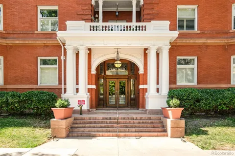 a front view of a building with potted plants