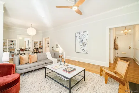 a living room with fireplace furniture and a large window