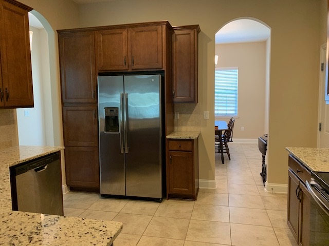 99 CanyonTrail St. Augustine, FL 32086 - Photo 12 of 19 a kitchen with a refrigerator and a sink