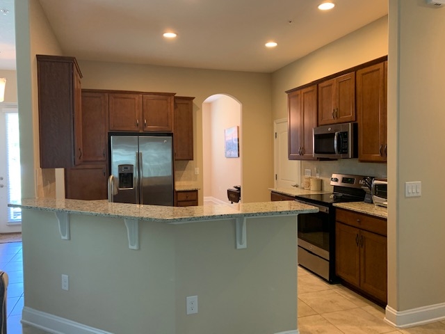 99 CanyonTrail St. Augustine, FL 32086 - Photo 7 of 19 a kitchen with stainless steel appliances granite countertop a stove a sink and a microwave