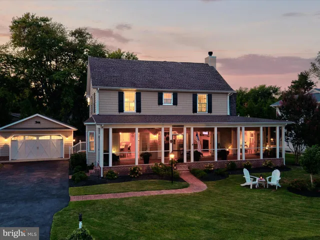 a front view of a house with a yard table and chairs
