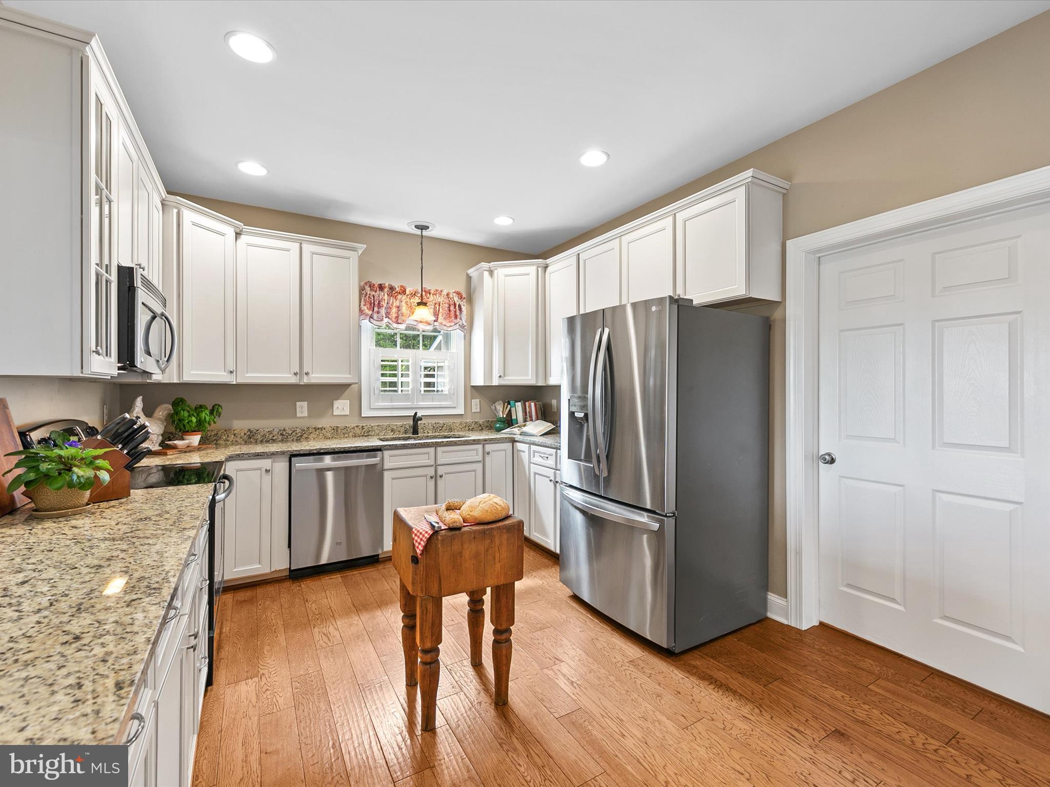 515 Stockley St Extension Rehoboth Beach, DE 19971 - Photo 23 of 104 a kitchen with a refrigerator and a stove top oven