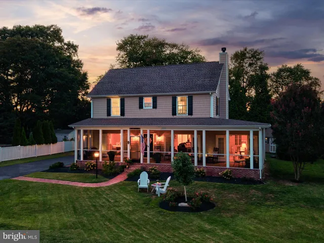a front view of a house with garden and porch