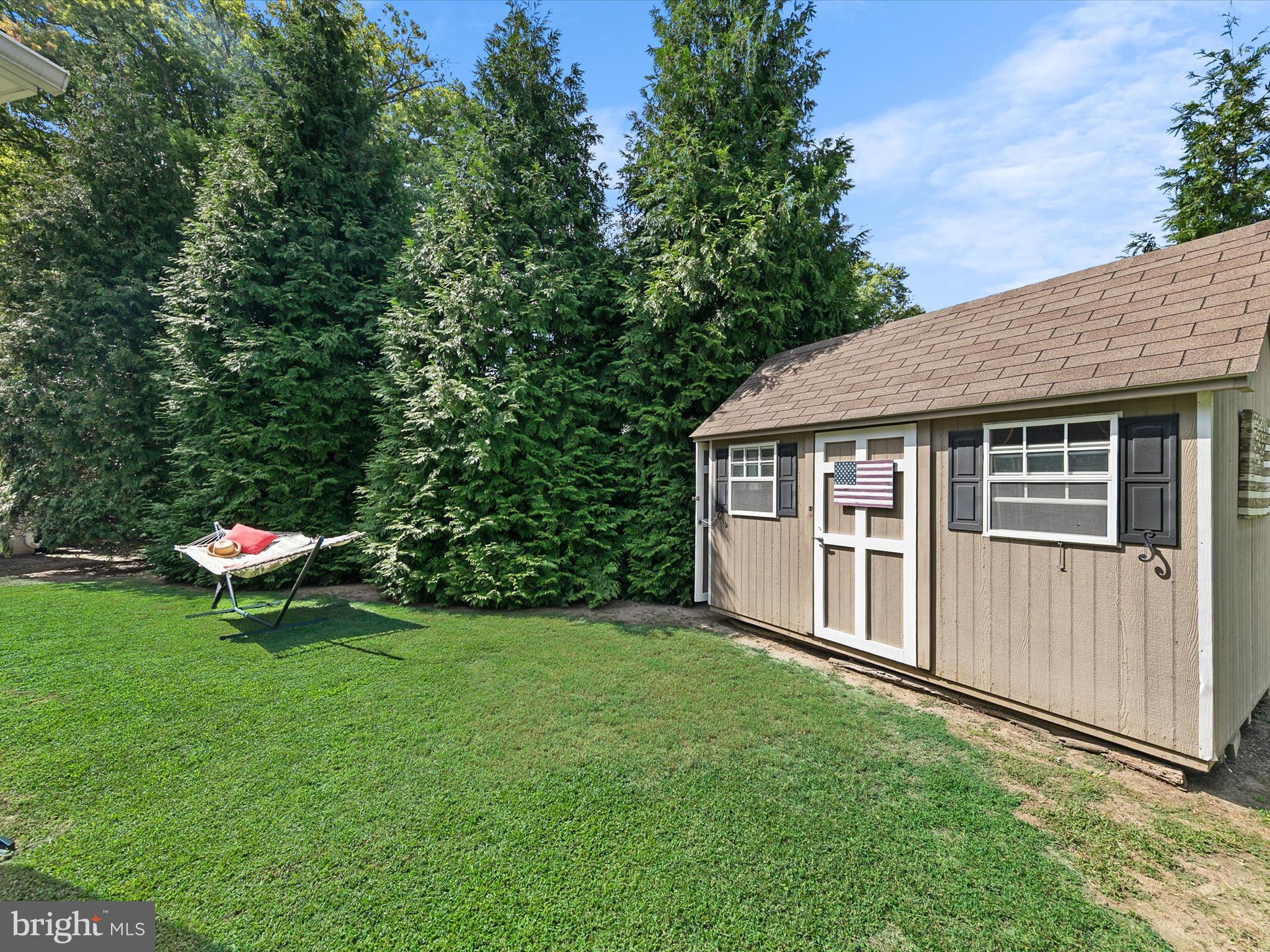 515 Stockley St Extension Rehoboth Beach, DE 19971 - Photo 60 of 104 a backyard of a house with table and chairs