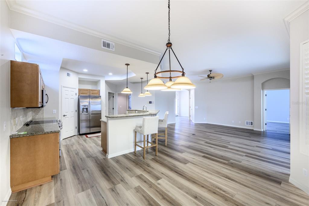 3959 San Rocco Drive, Unit 612 Punta Gorda, FL 33950 - Photo 13 of 41 a view of a kitchen and dining room with wooden floor