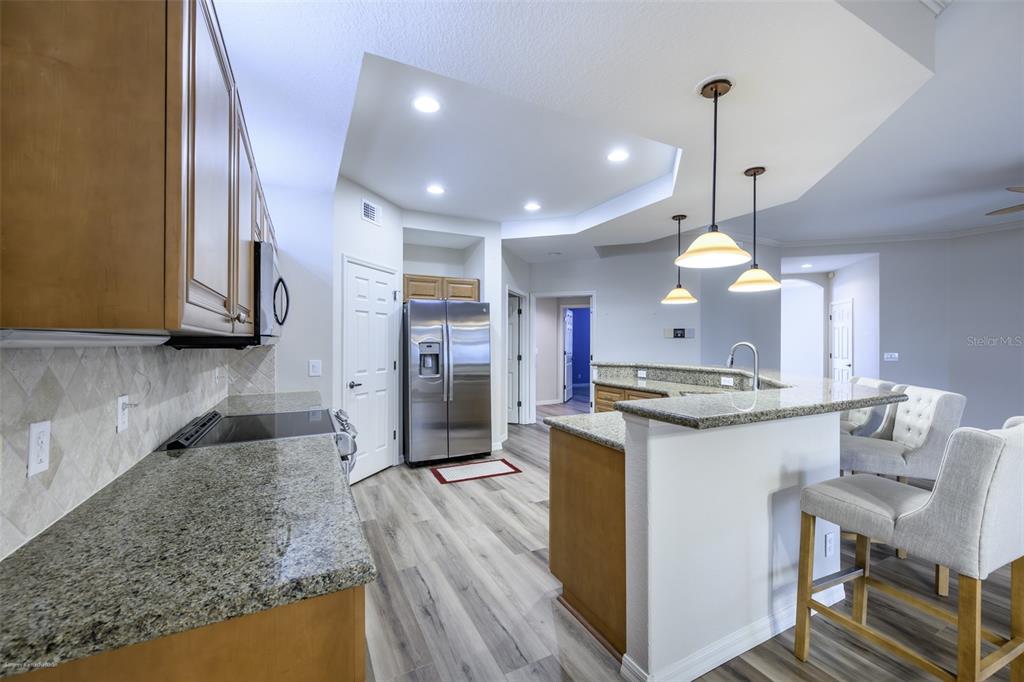 3959 San Rocco Drive, Unit 612 Punta Gorda, FL 33950 - Photo 14 of 41 a kitchen with stainless steel appliances granite countertop a sink a stove and a refrigerator