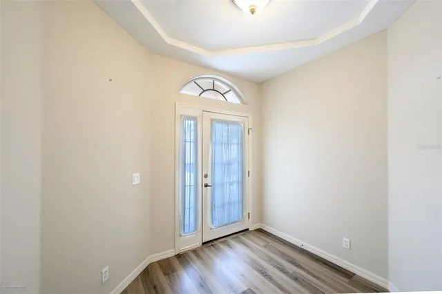 a view of front door with wooden floor