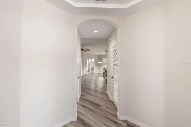 a view of a hallway with wooden floor and staircase
