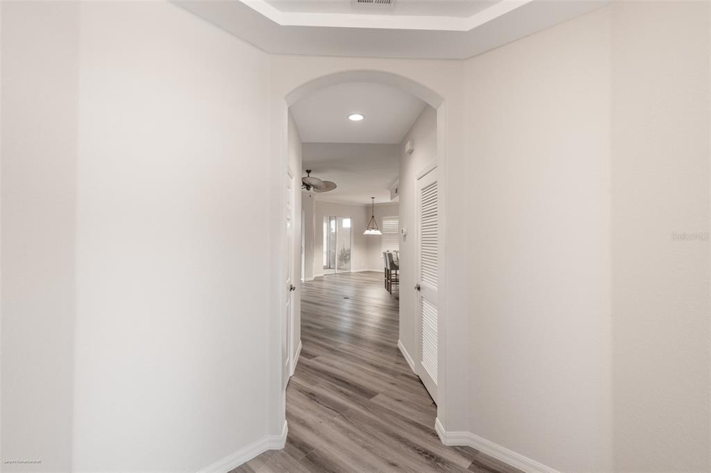 3959 San Rocco Drive, Unit 612 Punta Gorda, FL 33950 - Photo 6 of 41 a view of a hallway with wooden floor and staircase