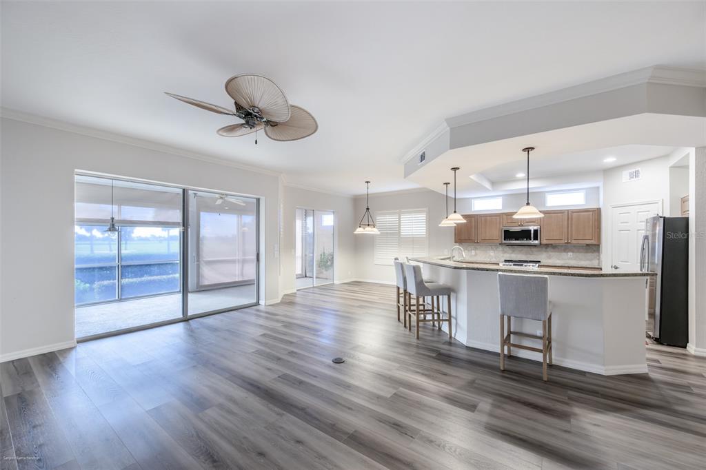 3959 San Rocco Drive, Unit 612 Punta Gorda, FL 33950 - Photo 7 of 41 a kitchen with stainless steel appliances granite countertop a refrigerator a stove top oven a sink dishwasher and white cabinets with wooden floor