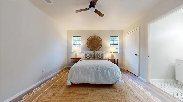 a bedroom with a bed and a mirror