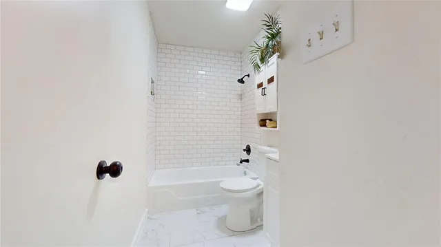 a bathroom with a toilet a sink and bathtub