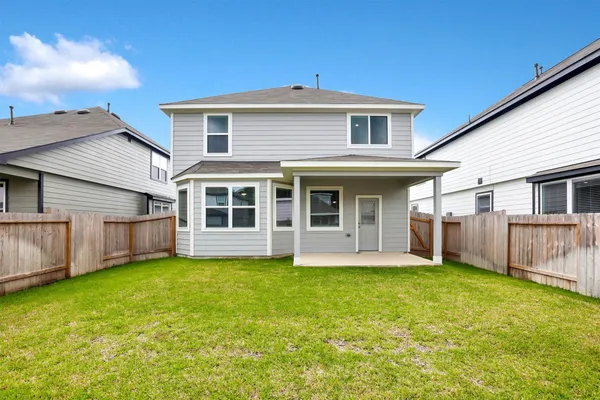 a view of a house with a yard and sitting area