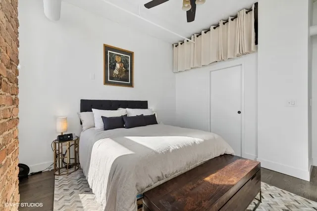 a bedroom with bed and wooden floor