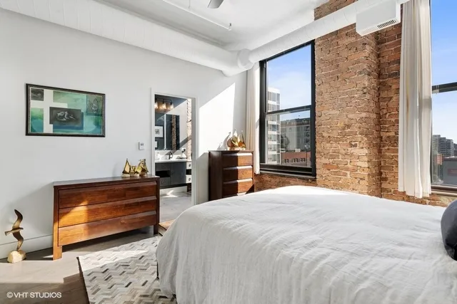 a bedroom with a bed and a dresser