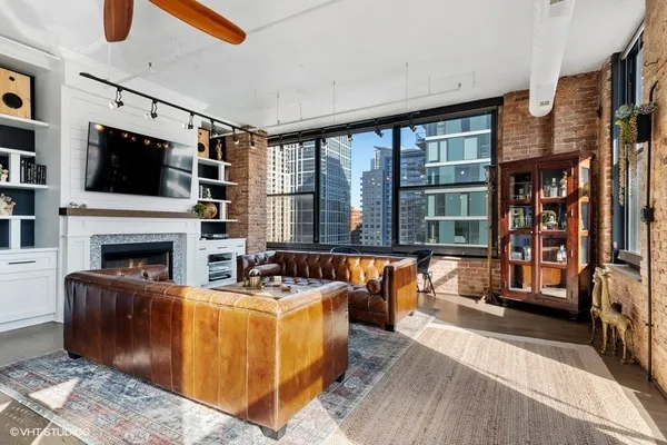 a living room with furniture a fireplace and a flat screen tv
