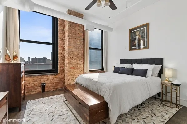 a bedroom with a bed and a window
