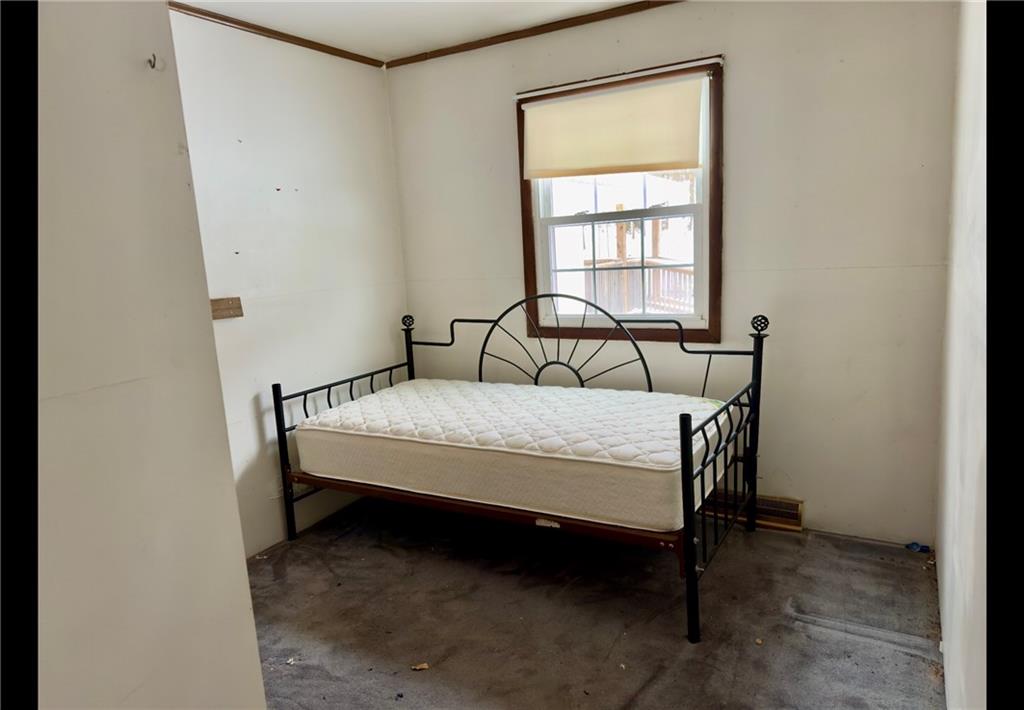 455 Adrian Sherrett Road Adrian, PA 16210 - Photo 8 of 11 a bed sitting in a bedroom next to a window