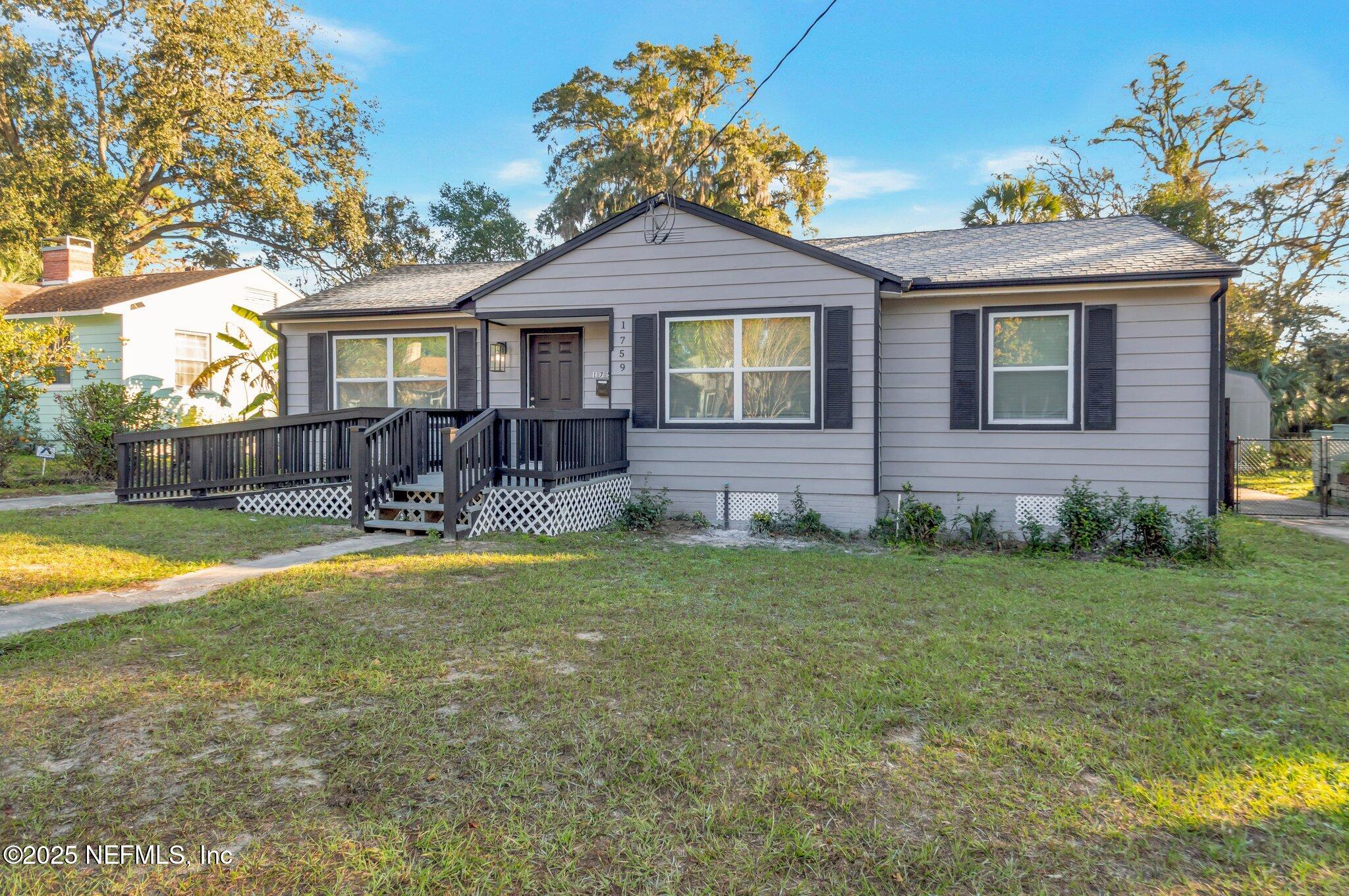 1759 Planters Road Jacksonville, FL 32207 - Photo 1 of 16 a front view of a house with a yard