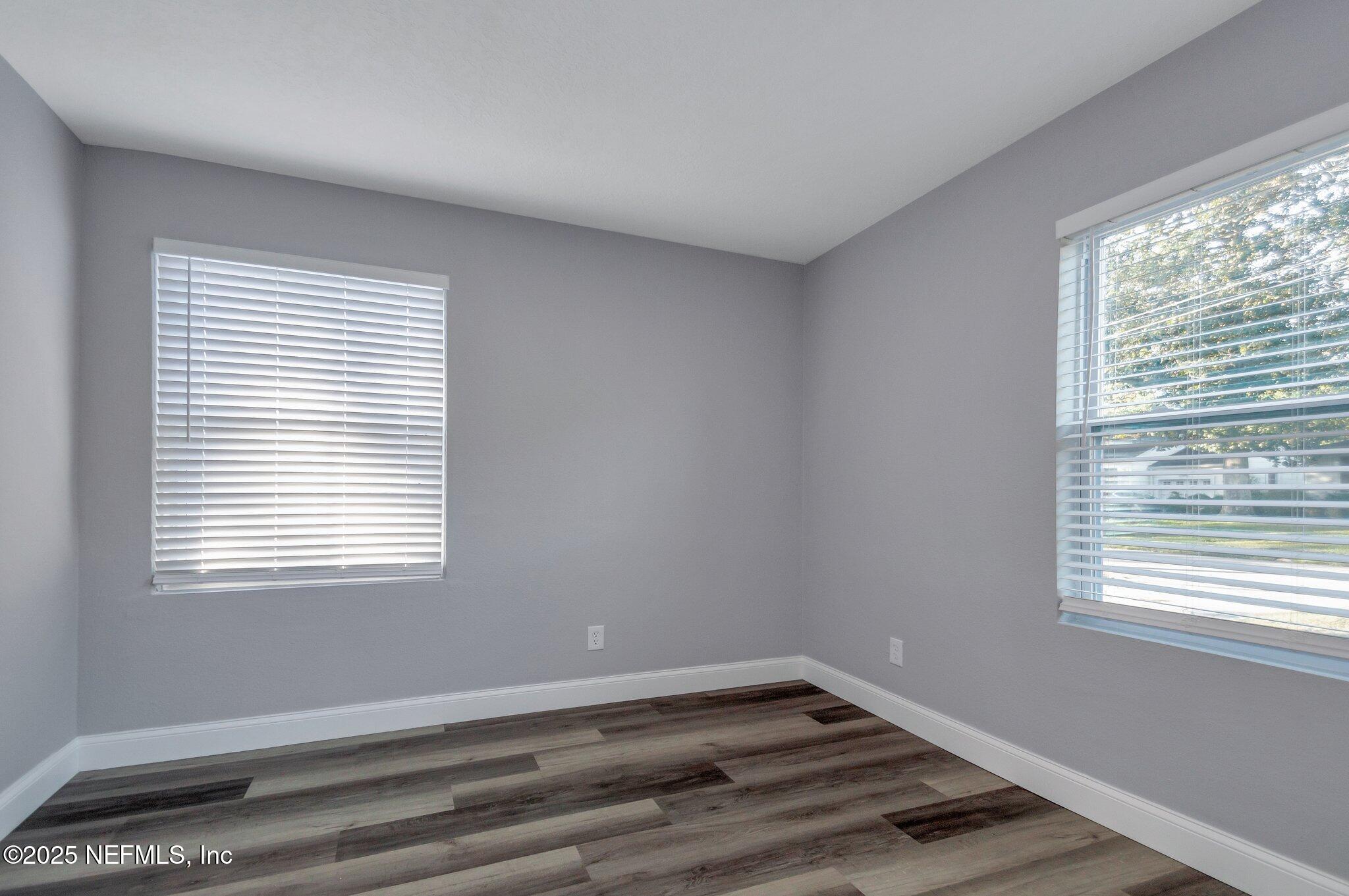 1759 Planters Road Jacksonville, FL 32207 - Photo 12 of 16 a view of an empty room with wooden floor and a window