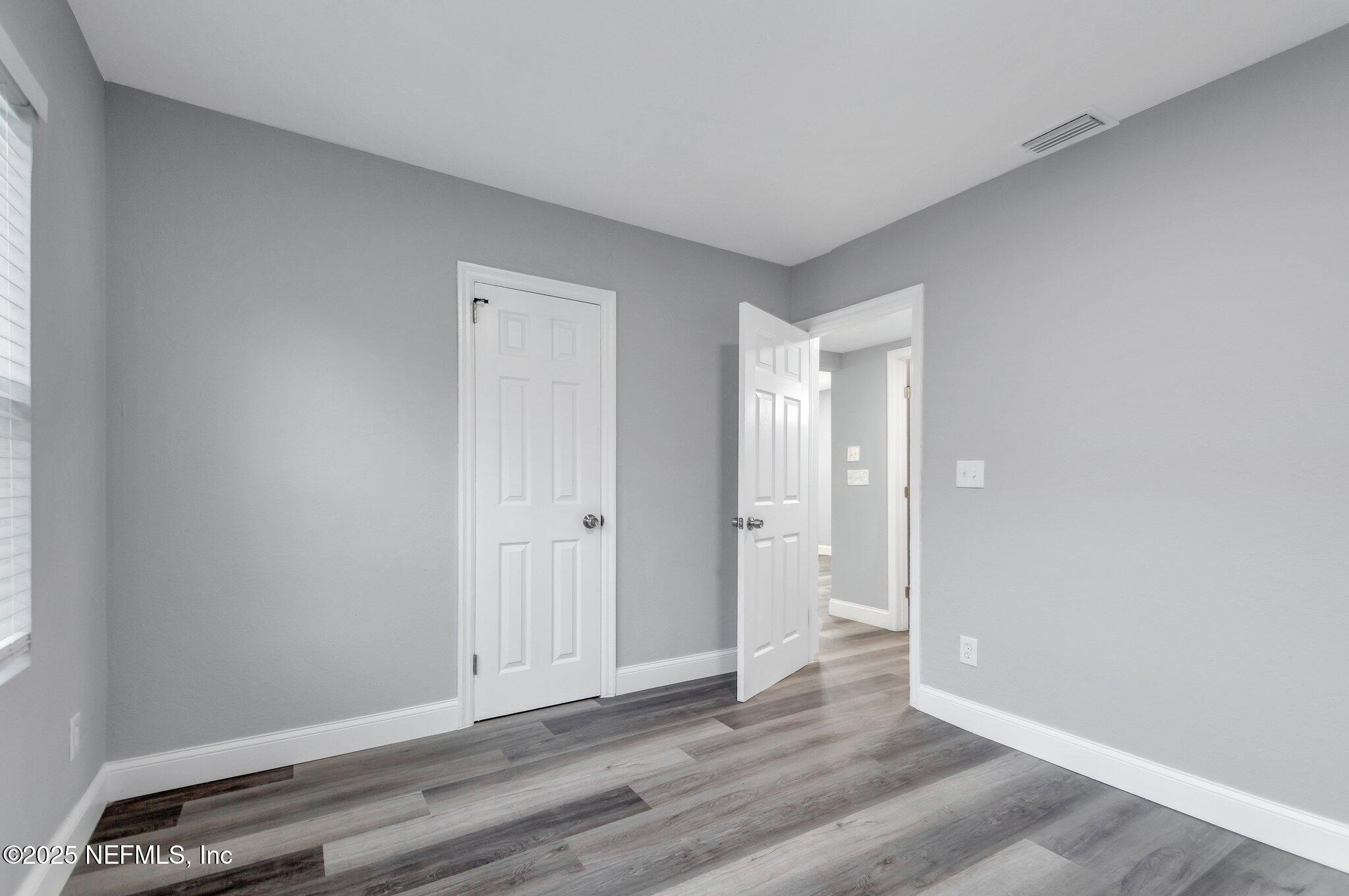 1759 Planters Road Jacksonville, FL 32207 - Photo 13 of 16 a view of an empty room and wooden floor