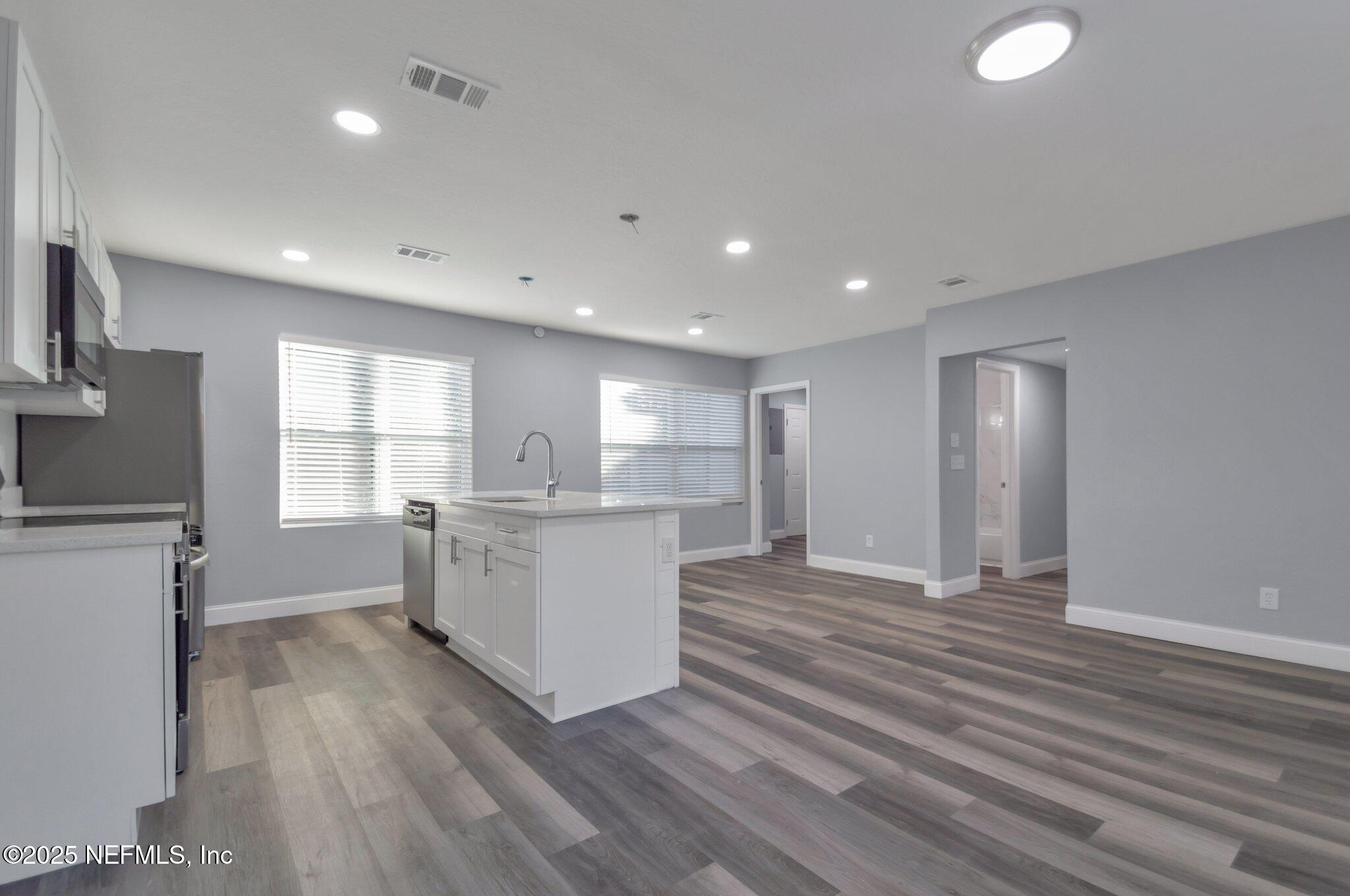 1759 Planters Road Jacksonville, FL 32207 - Photo 5 of 16 a view of an empty room with a window and wooden floor