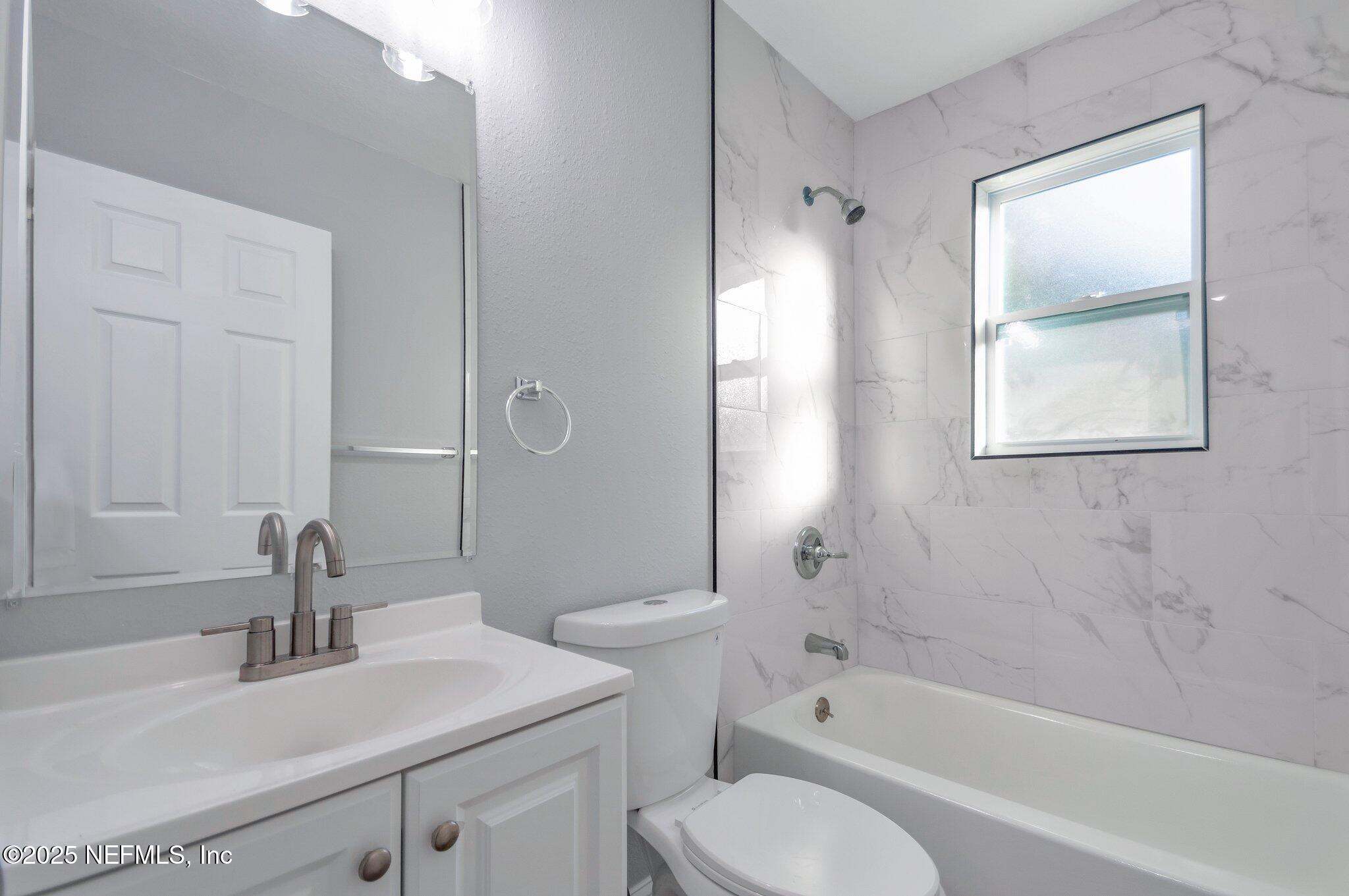 1759 Planters Road Jacksonville, FL 32207 - Photo 8 of 16 a bathroom with a sink toilet tub and shower