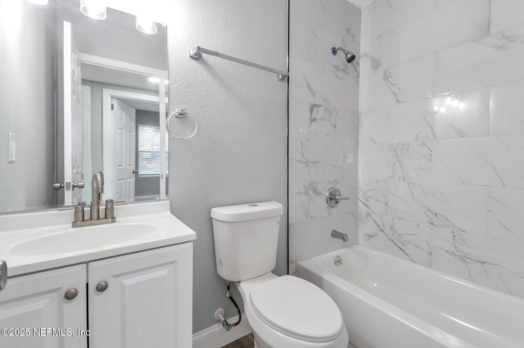 1759 Planters Road Jacksonville, FL 32207 - Photo 9 of 16 a bathroom with a sink a toilet and shower