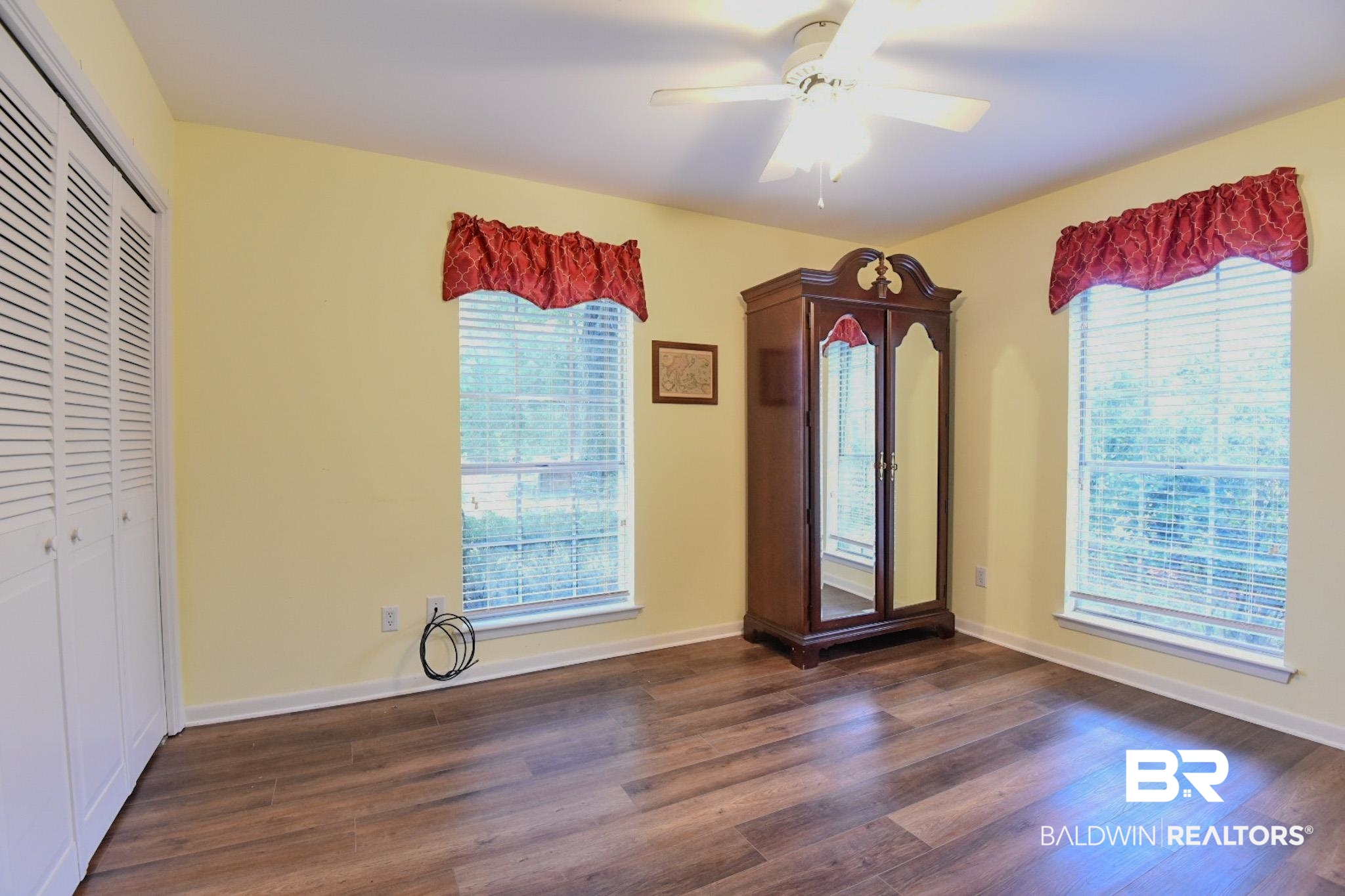 90 Paddock Drive Fairhope, AL 36532 - Photo 20 of 23 Unfurnished bedroom with a closet, dark wood-style flooring, and a ceiling fan