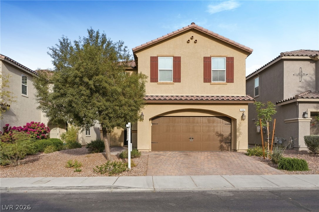 150 Fulgora Street Henderson, NV 89074 - Photo 6 of 92 Mediterranean / spanish home featuring stucco siding, an attached garage, decorative driveway, and a tiled roof