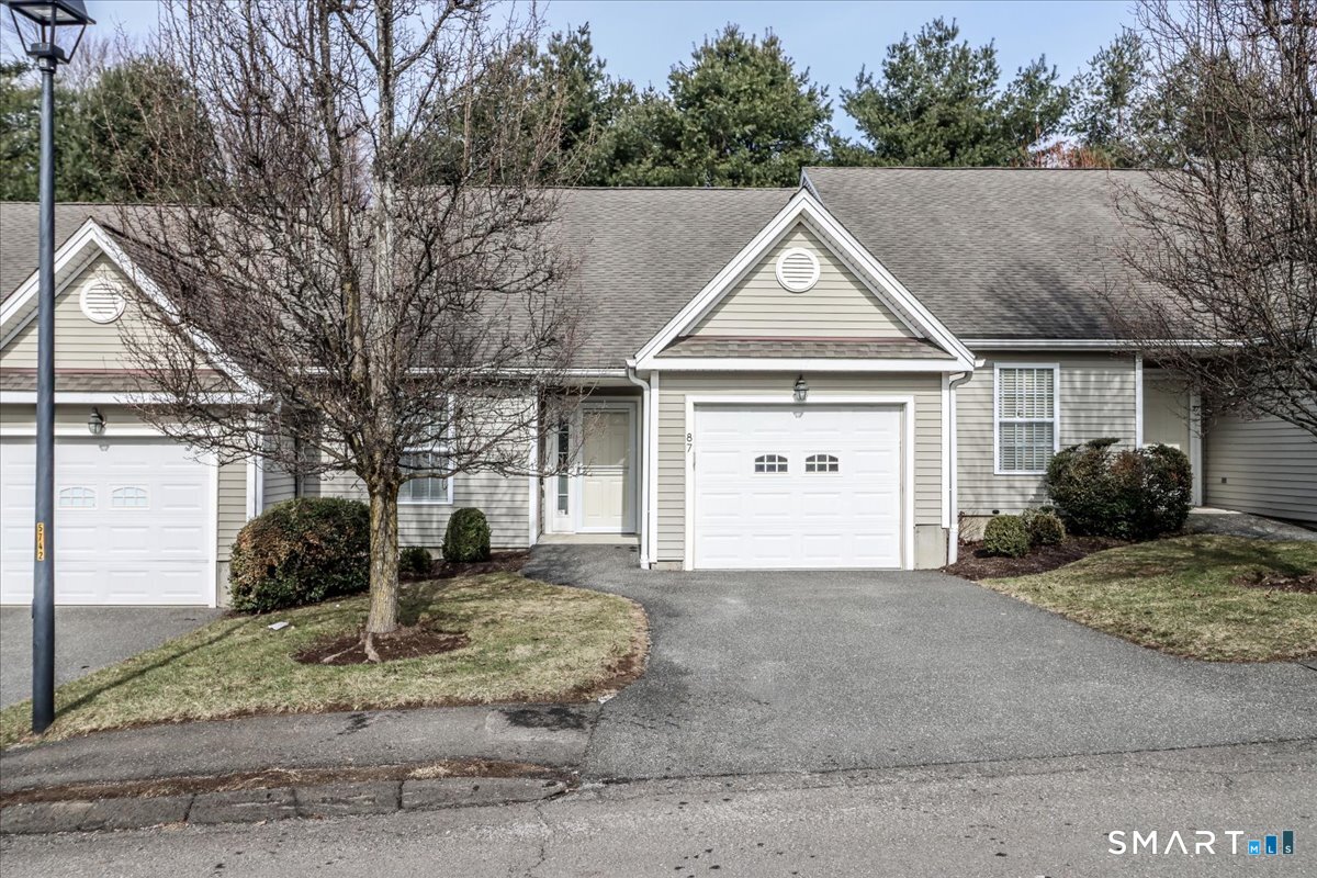 87 Haley Lane, Unit 87 Newtown, CT 06482 - Photo 2 of 39 a view of a house with a yard and large tree