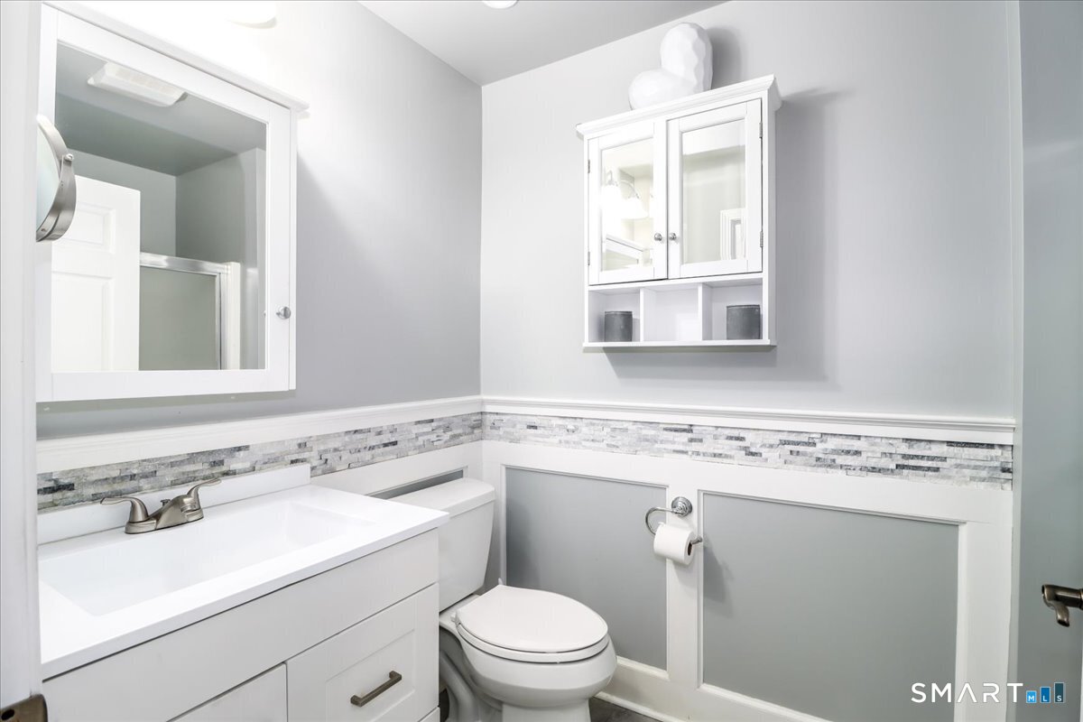 87 Haley Lane, Unit 87 Newtown, CT 06482 - Photo 22 of 39 a bathroom with a sink a toilet and a mirror