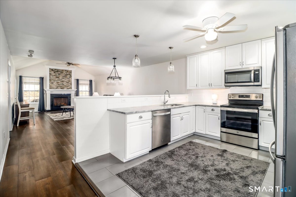 87 Haley Lane, Unit 87 Newtown, CT 06482 - Photo 5 of 39 a kitchen with a sink stove and refrigerator